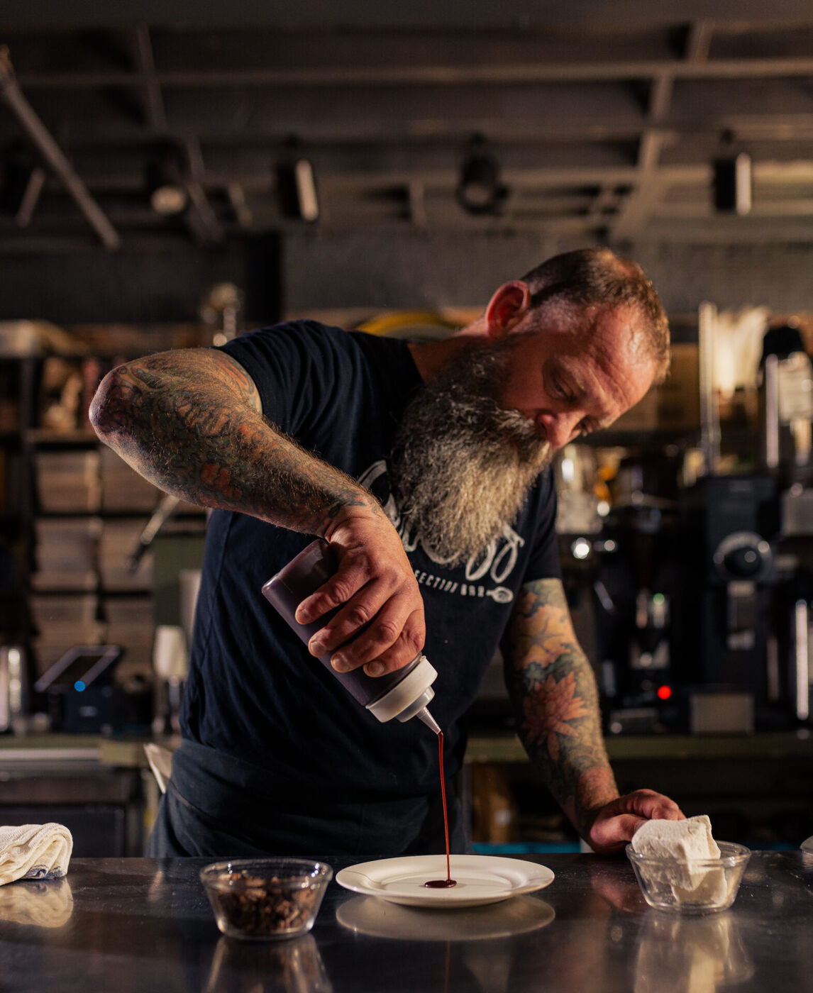 Pastry chef and owner Brant Dadaleares plating a dessert behind the bar